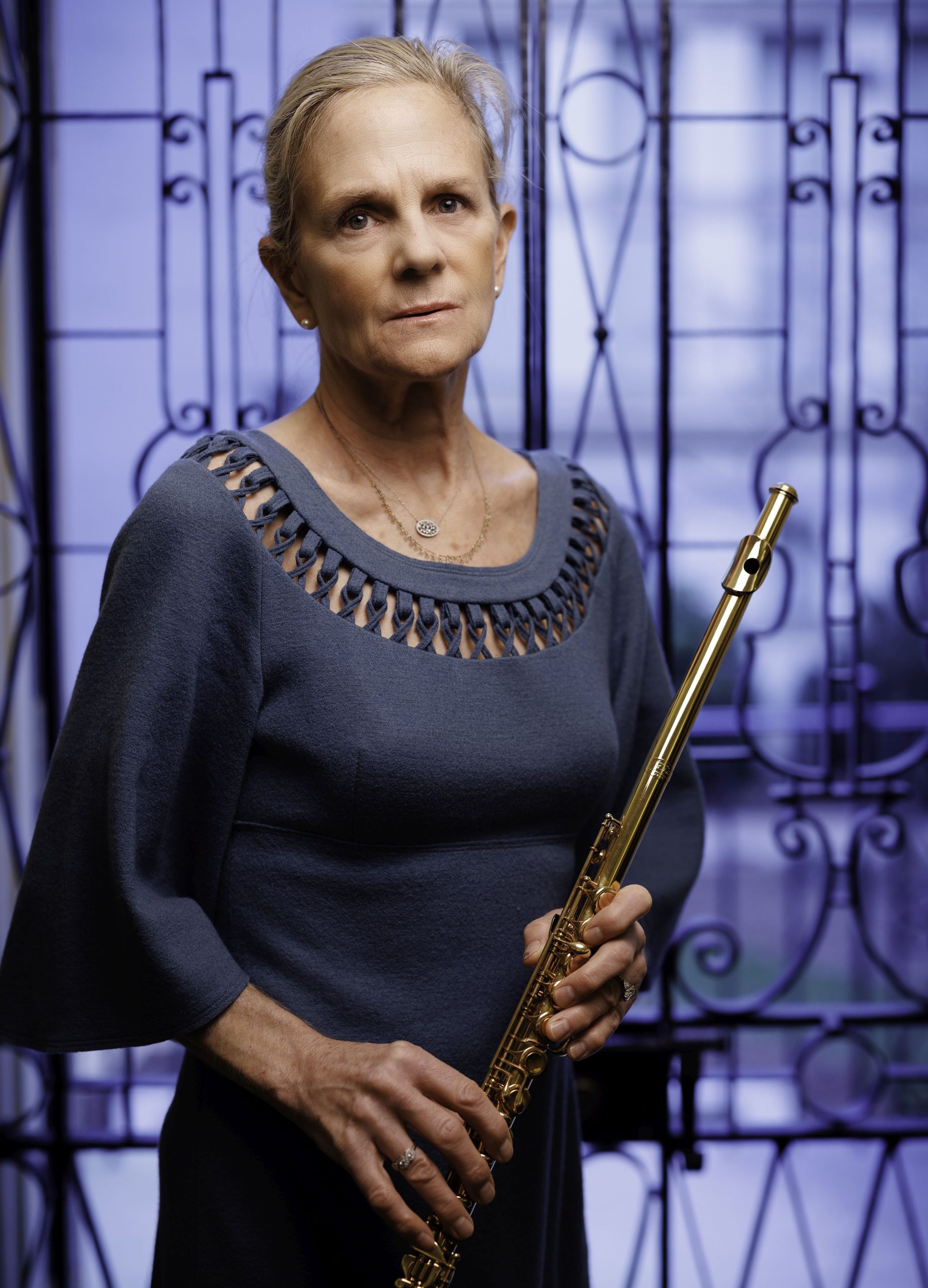 Carol Lynn Ward-Bamford holding the DCM 10, the flute that Dayton C. Miller made by hand in 22k gold, with 18k keys. Photo by Shawn Miller/Library of Congress. 